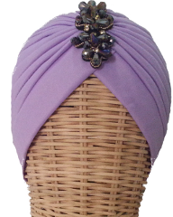 Turbante Malva. Turbante de tela elástica plisada en color malva con broche central de pasamaneria en morado. : PVP 35 euros